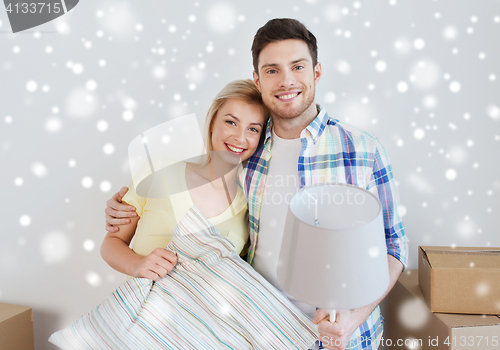 Image of happy couple with stuff moving to new home