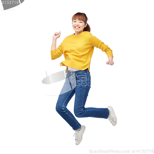 Image of happy asian woman jumping over white