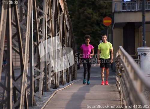 Image of multiethnic couple jogging in the city