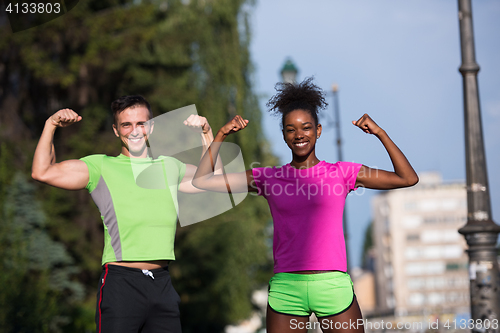 Image of portrait of young multietnic jogging couple ready to run