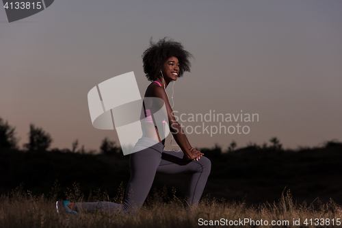 Image of black woman is doing stretching exercise relaxing and warm up