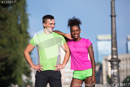 Image of portrait of young multietnic jogging couple ready to run