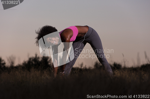 Image of black woman is doing stretching exercise relaxing and warm up