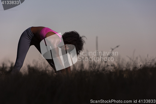 Image of black woman is doing stretching exercise relaxing and warm up