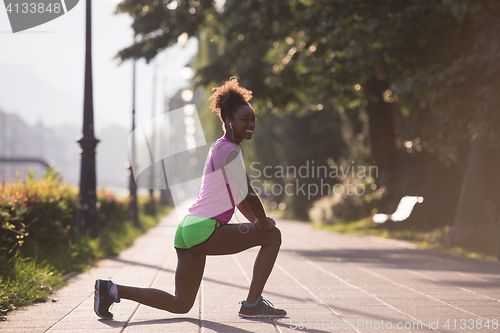 Image of Black woman doing warming up and stretching