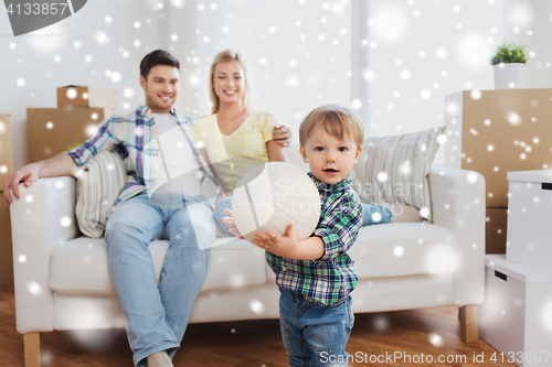 Image of happy little boy with ball over parents at home