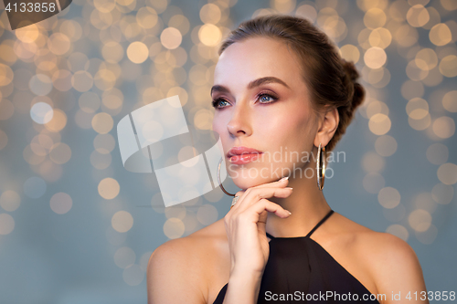 Image of beautiful woman in black wearing diamond jewelry