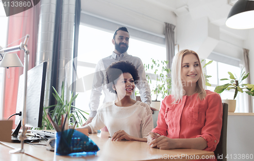Image of happy creative team in office