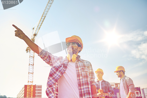 Image of builders pointing finger aside on construction