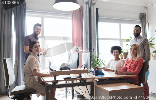 Image of happy creative team in office