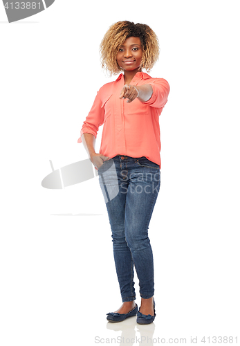 Image of happy african woman pointing finger at you