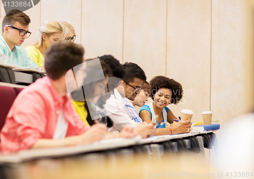 Image of group of students with coffee writing on lecture