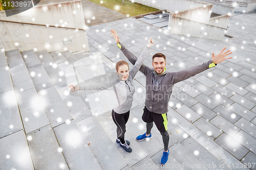 Image of happy couple of sportsmen outdoors on city street