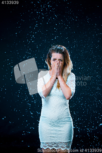 Image of The young girl standing under running water