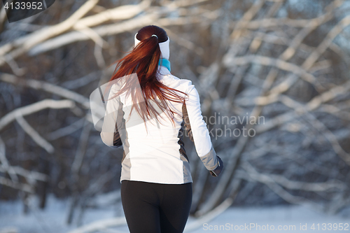 Image of Young girl engaged in running