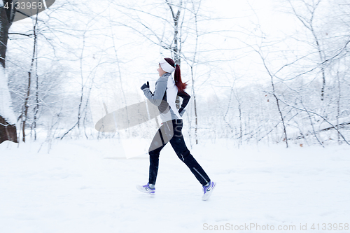 Image of Athlete running in winter woods