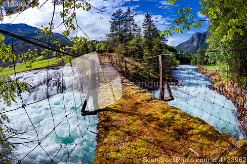 Image of Suspension bridge over the mountain river, Norway.