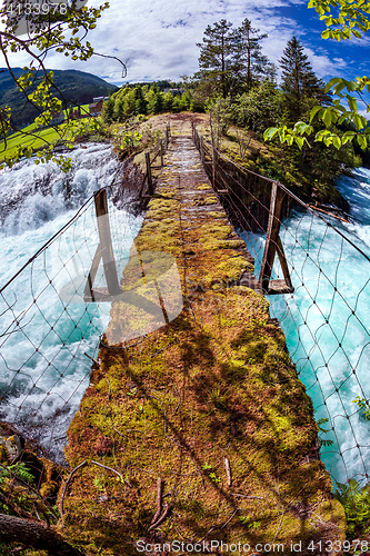 Image of Suspension bridge over the mountain river, Norway.