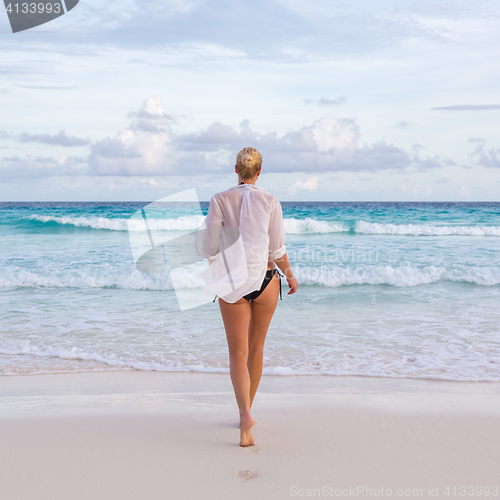 Image of Woman on summer vacations at tropical beach of Mahe Island, Seychelles.