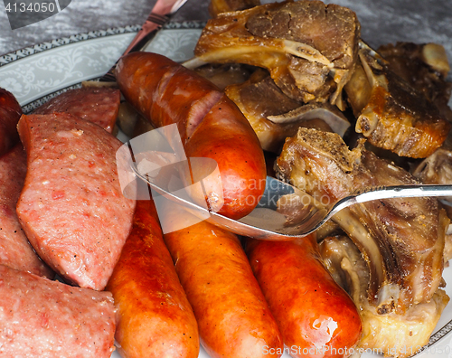 Image of Closeup of a tray with delicious sausages and sheep ribs