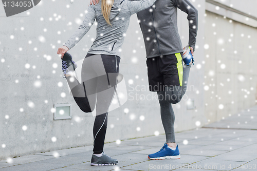 Image of close up of couple stretching legs outdoors