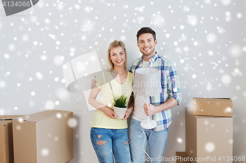 Image of smiling couple with boxes moving to new home