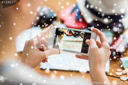 Image of close up of woman with smartphone and travel stuff