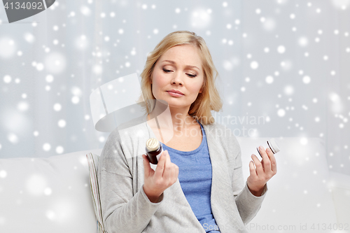 Image of woman with medicine jars at home