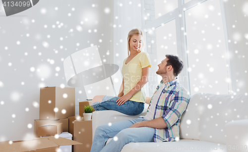 Image of happy couple with cardboard boxes at new home