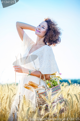 Image of beautiful smiling woman outdoors in barley field