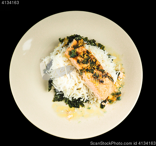 Image of Delicious piece of salmon on a bed of long grained rice, and spi