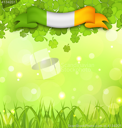 Image of Glowing nature background with shamrocks, grass and Irish flag f