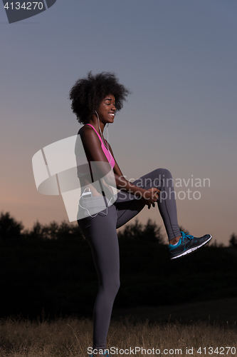 Image of black woman is doing stretching exercise relaxing and warm up