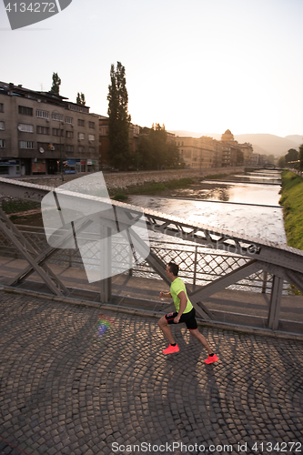 Image of a young man jogging in the city