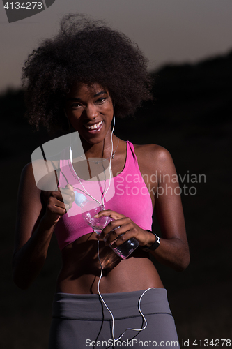 Image of african american woman jogging in nature