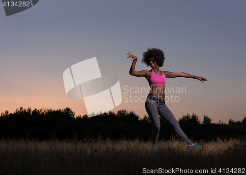 Image of black woman is doing stretching exercise relaxing and warm up