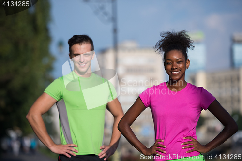 Image of portrait of young multietnic jogging couple ready to run