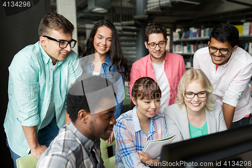 Image of international students with computers at library