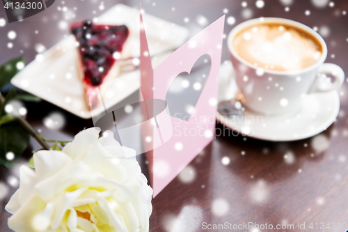 Image of close up of greeting card with heart and coffee