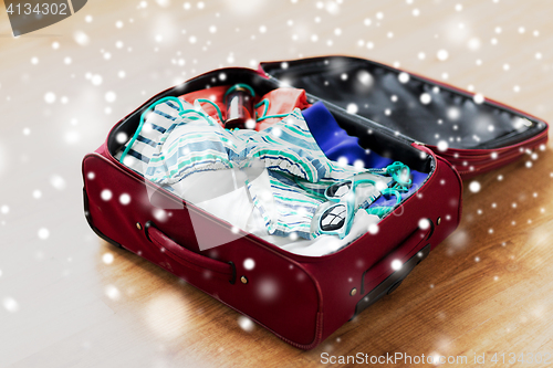 Image of close up of travel bag with beach clothes