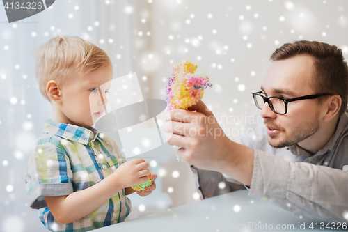 Image of father and son playing with ball clay at home