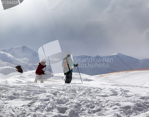 Image of Father and daughter on ski resort after snowfall at sun day with