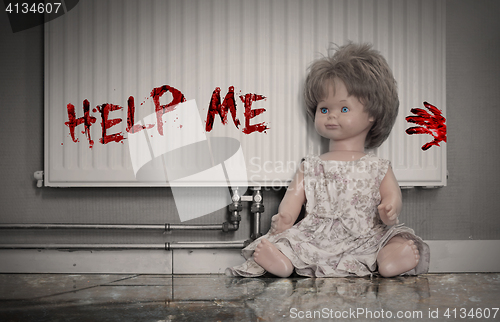 Image of Concept of child abuse - Bloody doll