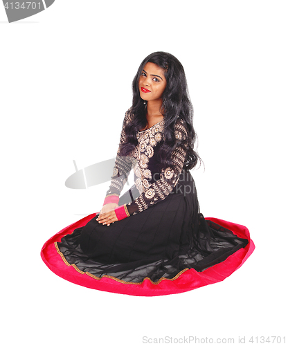 Image of Pretty woman sitting on floor.
