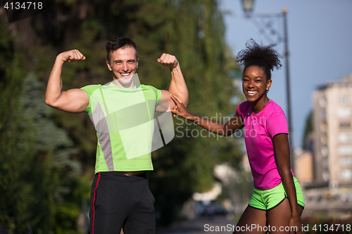 Image of portrait of young multietnic jogging couple ready to run