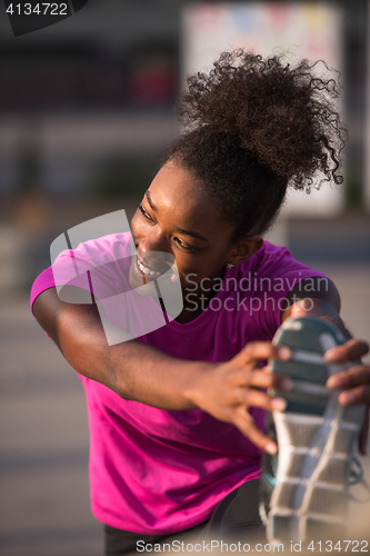 Image of African American woman doing warming up and stretching