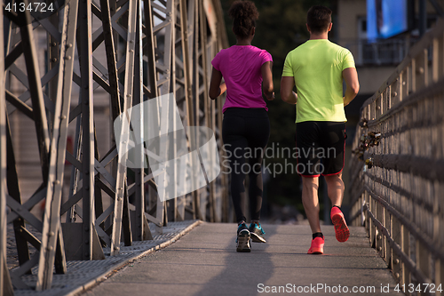 Image of multiethnic couple jogging in the city