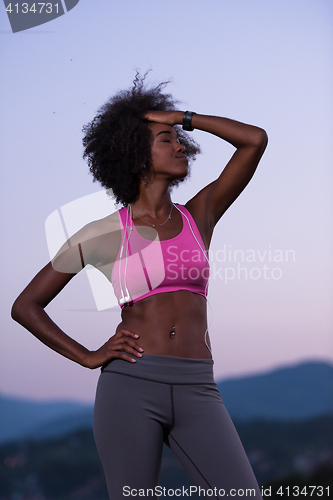 Image of portrait of african american woman jogging in nature