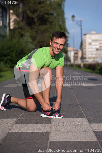 Image of Young athlete, runner tie shoelaces in shoes