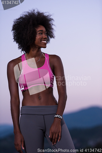 Image of portrait of african american woman jogging in nature